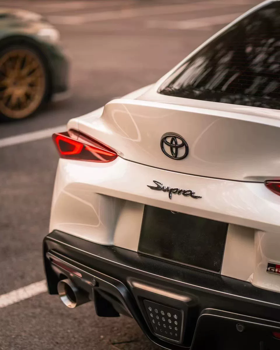 Toyota A90, A91 Used OEM Emblem Badge matte black, red accent A90 Toyota A90, A91 Used OEM Emblem Badge matte black, red accent A90 - detail image 8