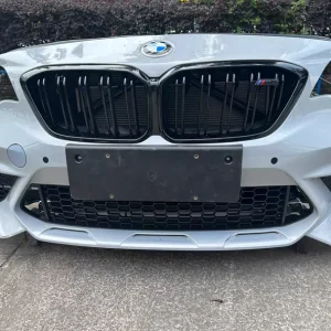 Used BMW 2 Series M2 F87 front bumper cover, straight-on front view, fitted with kidney grilles and lower intake mesh