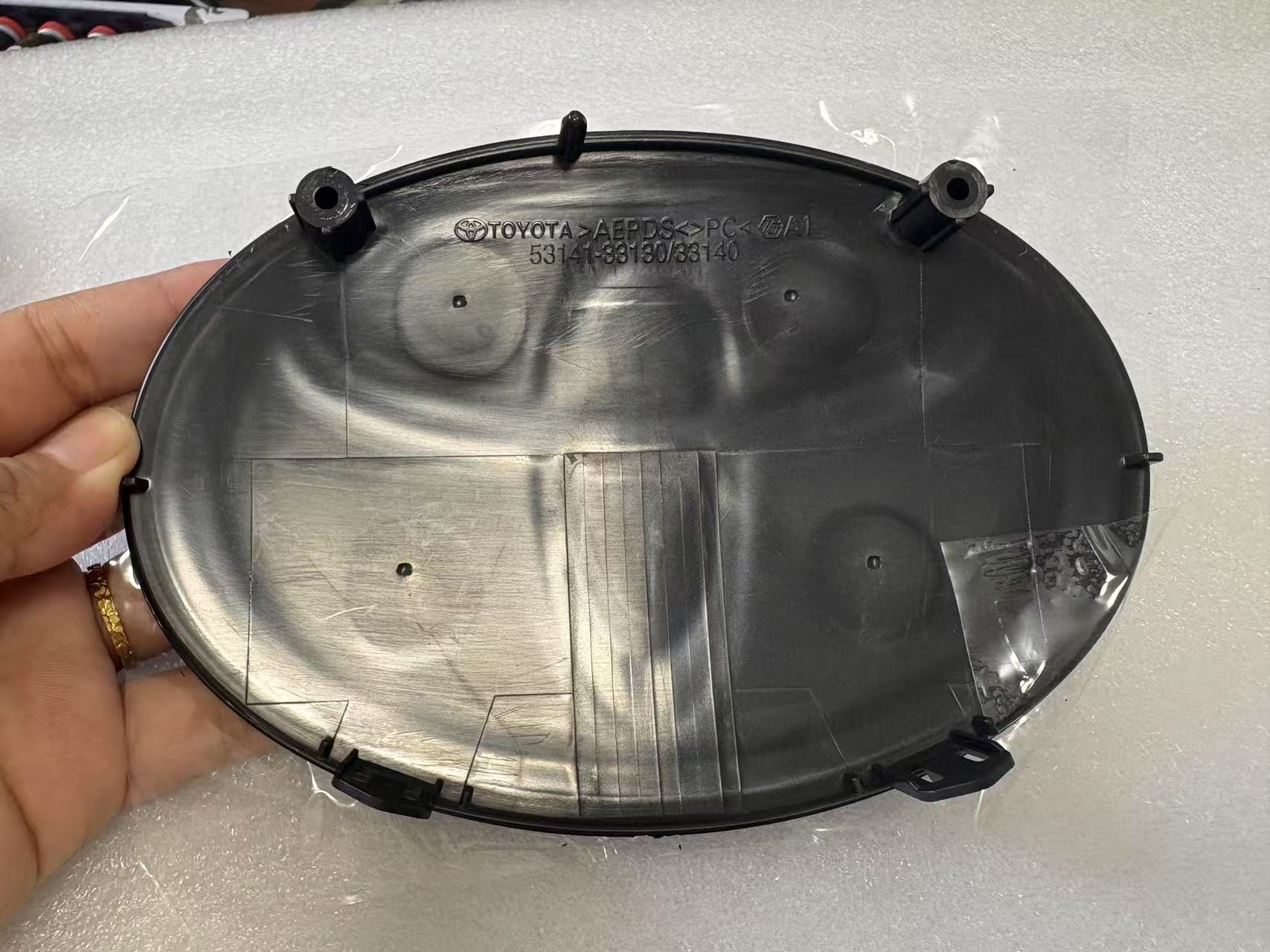 Toyota grille emblem rear housing with molded 53141-33130 and 53141-33140 references