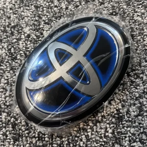 Toyota 2021, 2022, 2023 Used OEM Radar-Compatible Grille Emblem hybrid style, radar/ACC compatible 90975-C2022