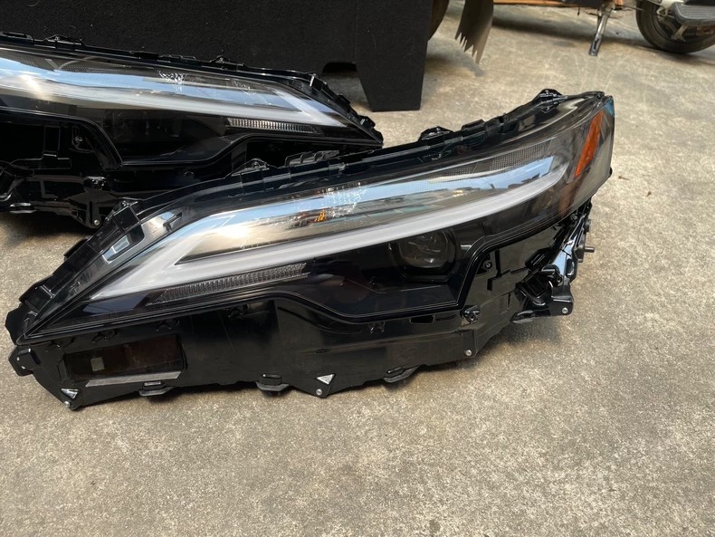 2025 Lexus RX350h used OEM LED headlight side view with clear wrap-around lens and LED projector