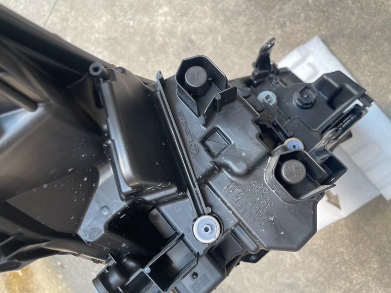 2025 Lexus RX350 used OEM LED headlight rear housing with multi-pin connector and molded LEXUS JAPAN LED 12V markings
