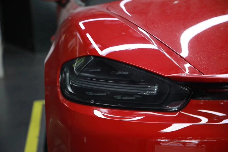 Left rear tail light close-up, PORSCHE marking on lens