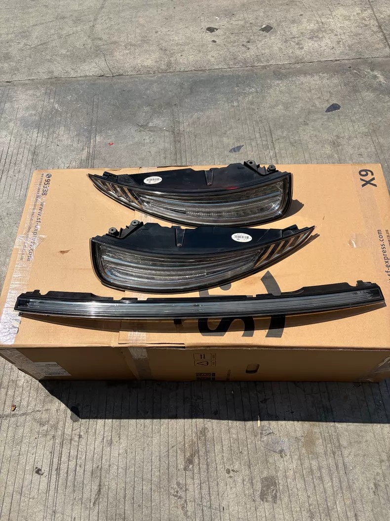 Porsche 911 991.1 clear lens LED rear tail light set 2012-2016: left and right tail lights with the rear centre reflective trim, laid out on a cardboard box