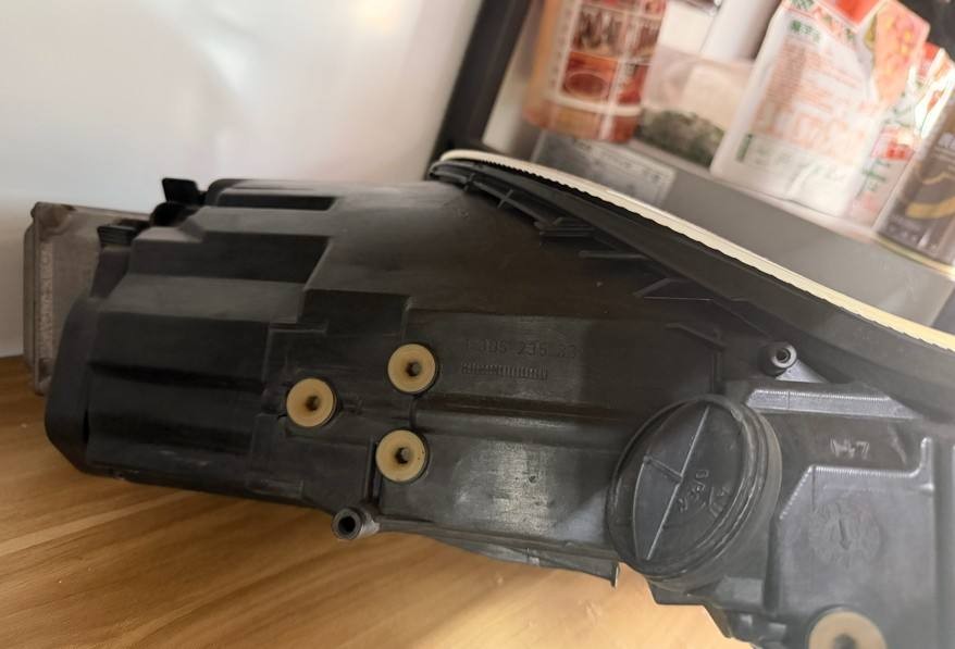Porsche 996 986 used headlight side view of rear housing with three rubber mounting grommets