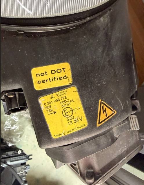 Porsche 996 986 used headlight rear housing close-up with type and warning labels