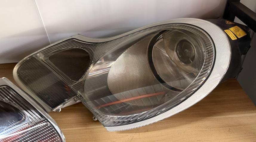 Porsche 996 986 pre-facelift headlight front lens view showing circular projector and turn signal section