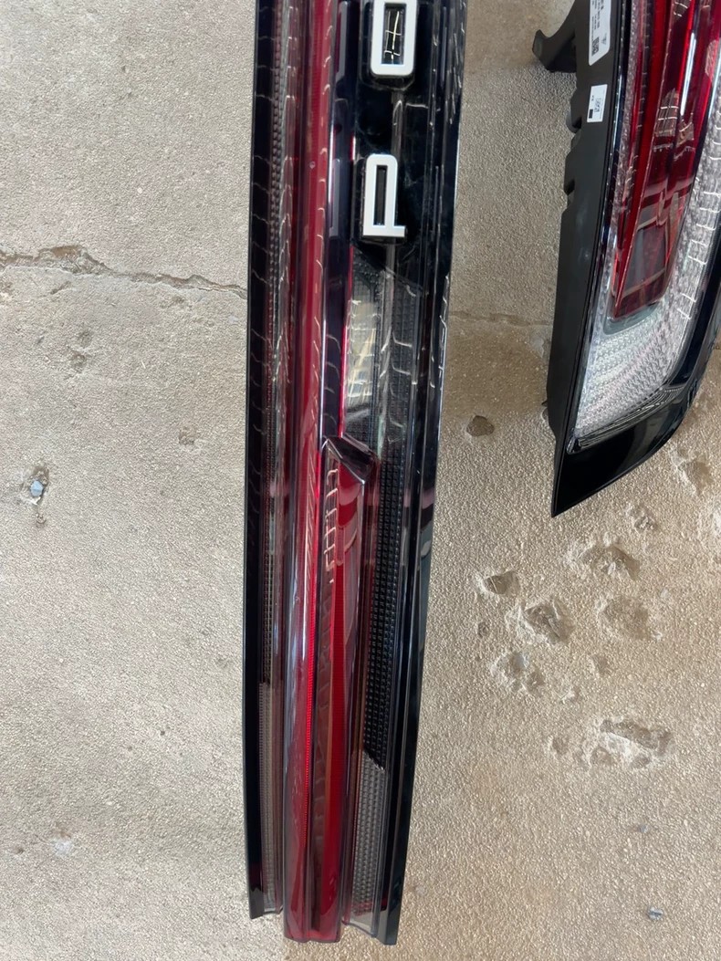 Porsche Cayenne 9YA tail light set showing PORSCHE lettering on the light bar