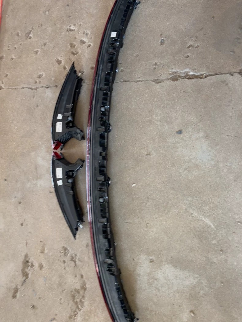 Porsche Cayenne 9YA tail light set housings, rear view with mounting brackets